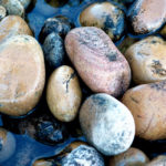 Water softly flows over creek stones - Photo by David Innes