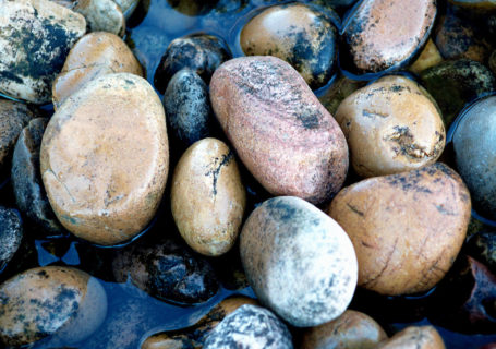 Water softly flows over creek stones - Photo by David Innes