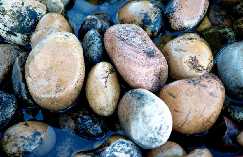 Water softly flows over creek stones - Photo by David Innes